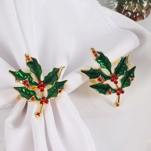 Christmas holly napkin rings with green enamel leaves and red rhinestones on gold base