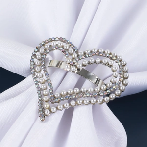 Sparkling heart napkin ring with pearls and rhinestones on a white fabric base