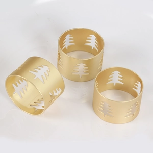 Three matte gold napkin rings featuring镂空 Christmas tree design on white background
