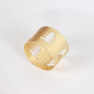 Matte gold Christmas napkin ring with hollowed-out tree design for festive table
