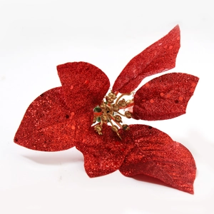 Christmas poinsettia napkin ring with red glitter petals and golden center on white backdrop