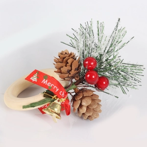 Christmas napkin ring with wooden circle, pine cones, red berries and gold bell