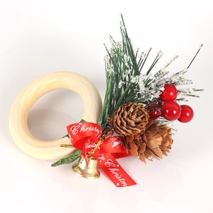 Detail of Christmas napkin ring with cedar, red berries, pine cones and a red bow