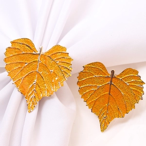 Golden heart-shaped leaf napkin rings with yellow enamel for elegant table decor