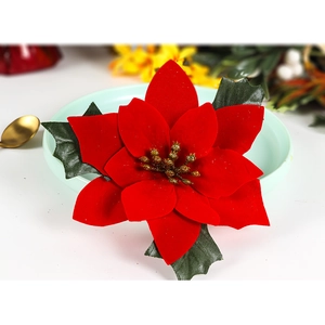 Handmade Christmas poinsettia napkin ring with red petals and gold beads for table setting