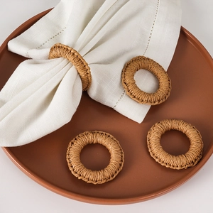 Set of 4 handmade woven napkin rings in natural brown straw for elegant dining tables