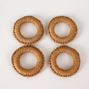 Detailed close-up of set of four woven jute napkin rings for rustic table settings