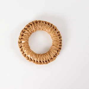 Detail of hand-woven hemp rope napkin ring showing natural fiber texture and white core