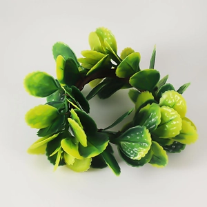 Handmade artificial green leaf napkin ring with realistic foliage texture on white background