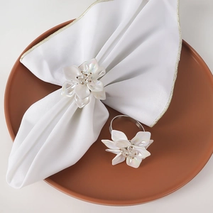 Elegant white acrylic flower napkin ring with rhinestones and silver metal loop band