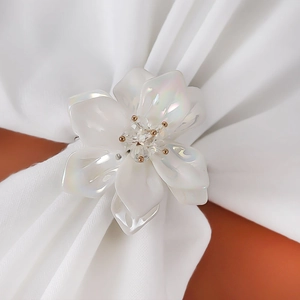 Elegant white acrylic flower napkin ring with pearl finish and crystal rhinestones