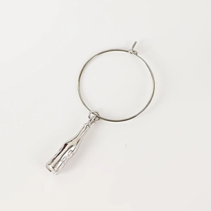 Detailed view of polished silver metal wine glass ring with creative bottle pendant