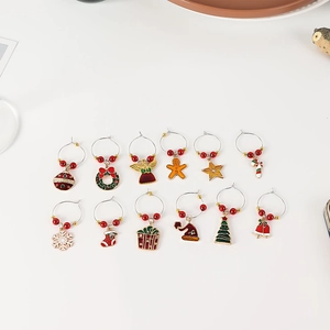 Detailed view of 12-piece Christmas wine glass charms with enamel festive pendants