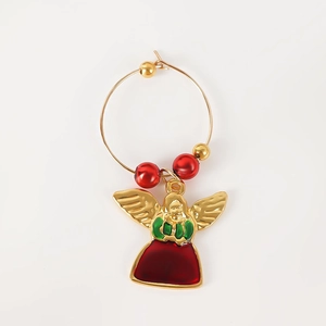 Detail of Christmas wine glass charm featuring a red and green angel pendant on golden ring