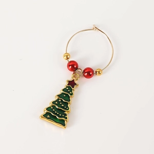 Detail of Christmas wine glass ring with green enamel tree and festive red gold beads