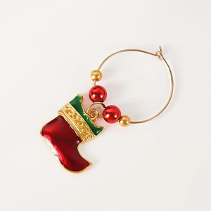 Detail of Christmas wine glass charm with red green stocking and golden beads décor