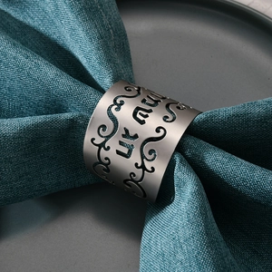 Modern matte silver hollow-out metal napkin ring with intricate scroll patterns