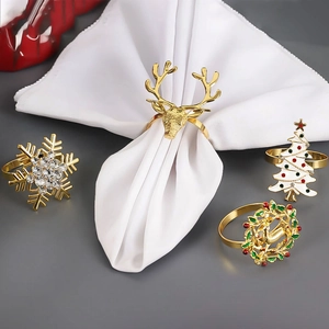 Christmas napkin ring set featuring golden reindeer, snowflake, tree, and wreath designs