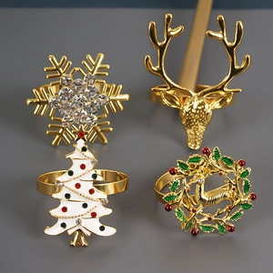 Christmas napkin rings set featuring gold deer, snowflake, tree and wreath designs