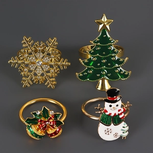 Detailed view of four festive Christmas napkin rings with snowflake and reindeer motifs