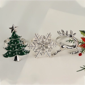 Detailed view of silver snowflake, green Christmas tree, and reindeer napkin rings