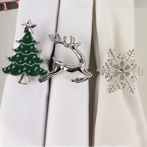 Christmas napkin ring set featuring green tree, silver reindeer and crystal snowflake