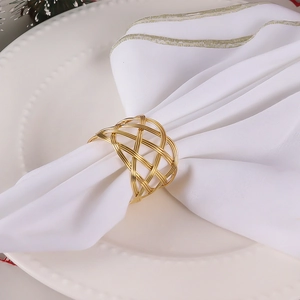 Handcrafted gold wire mesh napkin ring on a white napkin for elegant table settings