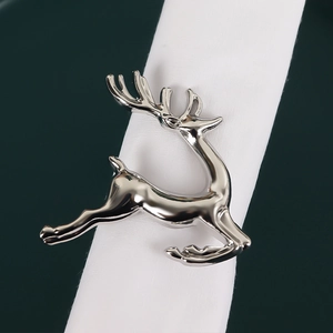 Silver deer metal napkin ring with diamond snowflake detail on white napkin set