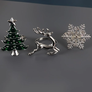 Detailed view of Christmas tree, reindeer, and snowflake metal napkin rings for table decor