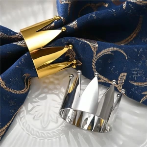 Detailed view of elegant gold crown napkin ring with a polished metallic mirror finish
