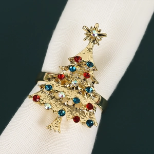 Detailed view of Christmas tree napkin ring with colorful rhinestones on white fabric