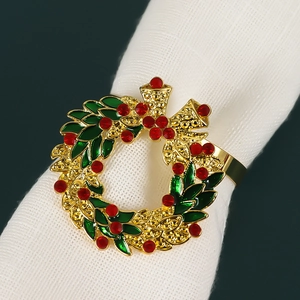 Detailed view of festive Christmas wreath napkin ring with red rhinestones and gold bow