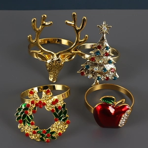 Set of 4 Christmas napkin rings with reindeer, tree, wreath and apple designs