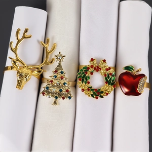 Detail of Christmas napkin rings featuring reindeer, tree, wreath and apple designs