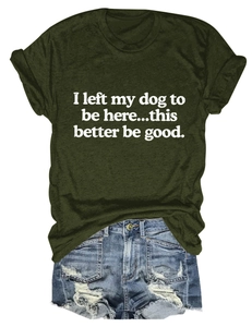 Flat lay of a green crewneck T-shirt with dog slogan and distressed denim shorts