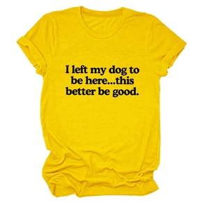 Detail of yellow cotton T-shirt featuring 'I left my dog to be here' text and fabric texture