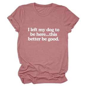 Close-up of pink crew neck T-shirt featuring white slogan print and rolled sleeve detail