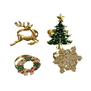 Set of Christmas napkin rings featuring golden deer, Xmas tree, wreath, and snowflake shapes