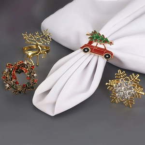 Christmas napkin ring set featuring golden elk, red car, wreath and snowflake designs
