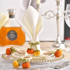 Handmade knitted pumpkin napkin rings with jute rope loops for autumn table setting