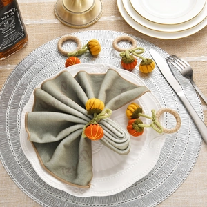 Handcrafted crochet pumpkin napkin ring with sage green napkin for festive table settings