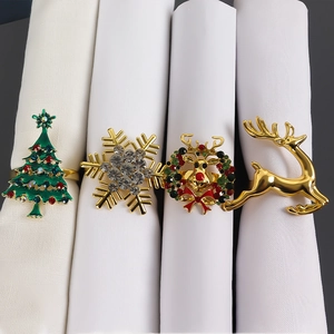 Macro detail of four festive napkin rings with rhinestone reindeer and snowflake designs