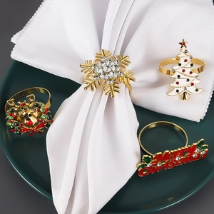 Christmas napkin rings set featuring gold snowflake, enamel tree, reindeer and Merry Christmas