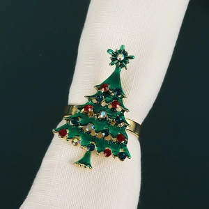 Detail of Christmas tree napkin ring with green enamel, rhinestones and gold band