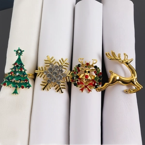 Set of four Christmas napkin rings featuring reindeer, snowflake, and tree designs