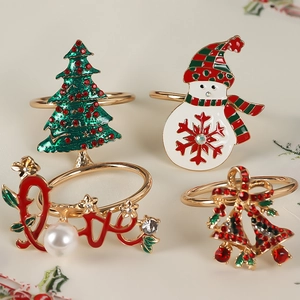Detailed view of four Christmas napkin rings featuring tree, snowman, bell and love designs