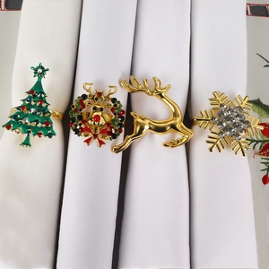 Detail showing four assorted Christmas napkin rings with reindeer, tree and snowflake motifs