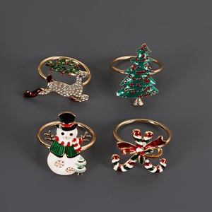 Detail view of four Christmas napkin rings including reindeer, tree, snowman, and candy cane