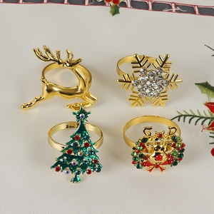 Detailed view of four festive gold napkin rings with reindeer and snowflake designs