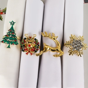 Detail of four festive napkin rings featuring Christmas tree, deer, wreath and snowflake designs